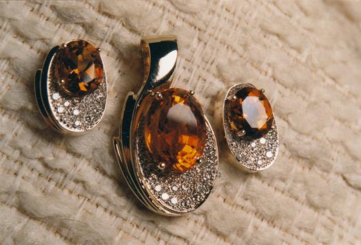 Gold pendant with matching earrings set with Citrine gemstones.