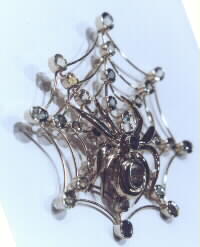 Gold spider web pendant with Sapphires